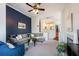 Cozy living room with blue accent wall, plush seating, and easy access to the kitchen at 4252 River Green Dr # 501, Atlanta, GA 30327