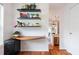 Cozy office nook with floating shelves, wooden desk, and natural light from the window at 4252 River Green Dr # 501, Atlanta, GA 30327