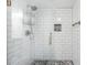 Contemporary shower featuring white subway tile, glass door and patterned floor at 4252 River Green Dr # 501, Atlanta, GA 30327