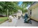Outdoor patio with chairs and lush, mature trees at 710 Crab Orchard Ct, Roswell, GA 30076