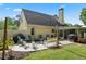 Outdoor living space with patio, multiple seating areas, and cozy string lights for evening enjoyment at 710 Crab Orchard Ct, Roswell, GA 30076