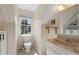 Bathroom with a unique style sink, bright natural light, and window view, giving a pleasant ambiance at 710 Crab Orchard Ct, Roswell, GA 30076
