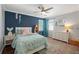 Colorful bedroom with blue accent wall, hardwood floors, and natural light, a vibrant, fun space at 710 Crab Orchard Ct, Roswell, GA 30076