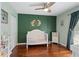 Stylish Bedroom with wood accent wall, charming decorations, and hardwood floors, a sweet, cozy space at 710 Crab Orchard Ct, Roswell, GA 30076