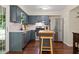 Modern kitchen featuring blue cabinets, stainless steel appliances, and a functional island, ideal for cooking at 710 Crab Orchard Ct, Roswell, GA 30076