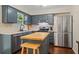 Well-lit kitchen with an island, stainless steel appliances, and a garden window at 710 Crab Orchard Ct, Roswell, GA 30076