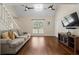 Bright living room featuring hardwood floors, vaulted ceilings, and comfortable seating arrangements at 710 Crab Orchard Ct, Roswell, GA 30076