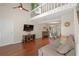 Open-concept living area with hardwood floors, two-story ceiling, and dining area, perfect for entertaining at 710 Crab Orchard Ct, Roswell, GA 30076