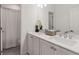 Bathroom with double vanity, white cabinets, and a shower with a glass door at 1070 Harper Dr, Alpharetta, GA 30076