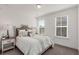 Bedroom with neutral carpet, white walls, large windows, and stylish furnishings at 1070 Harper Dr, Alpharetta, GA 30076