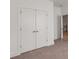 Bedroom featuring double doors, neutral carpet, and white walls at 1070 Harper Dr, Alpharetta, GA 30076
