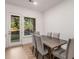 An eat-in dining area with a wooden table is adjacent to a window and a door that leads to the outside at 1070 Harper Dr, Alpharetta, GA 30076
