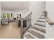 Open-concept floor plan, hardwood floors and stairway adjacent to the kitchen and living room at 1070 Harper Dr, Alpharetta, GA 30076