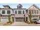 New construction townhomes with brick and siding exteriors, two-car garages, and professionally landscaped front yards at 1070 Harper Dr, Alpharetta, GA 30076