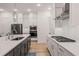 A modern, open-concept kitchen features stainless appliances and white subway tile backsplash at 1070 Harper Dr, Alpharetta, GA 30076
