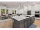 This kitchen has a kitchen island, recessed lights, stainless steel appliances, and overlooks the living area at 1070 Harper Dr, Alpharetta, GA 30076