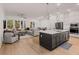 Open concept kitchen with stainless steel appliances, hardwood flooring and a living area with natural light at 1070 Harper Dr, Alpharetta, GA 30076