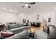 A comfortable living room overlooks a modern kitchen, and features a large gray sectional, recessed lighting, and hardwood floors at 1070 Harper Dr, Alpharetta, GA 30076
