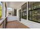 Covered porch with wood flooring, white siding, and screened windows for enjoying the outdoors in comfort at 1070 Harper Dr, Alpharetta, GA 30076