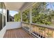 View of a screened in porch with wood flooring and white railings, providing an outdoor living space at 1070 Harper Dr, Alpharetta, GA 30076