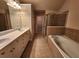 Bathroom features double vanity, soaking tub, and tiled shower at 10856 Ellicot Way, Alpharetta, GA 30022