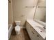 Bathroom features a white vanity, a toilet, and a shower with tile surround at 10856 Ellicot Way, Alpharetta, GA 30022