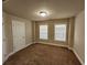 Bedroom with neutral walls, carpet flooring, and a window at 10856 Ellicot Way, Alpharetta, GA 30022