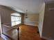 Spacious dining room with hardwood floors, a chandelier, and large windows, providing an elegant setting at 10856 Ellicot Way, Alpharetta, GA 30022