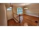 Bright dining area featuring hardwood floors, classic chandelier, and a large window at 10856 Ellicot Way, Alpharetta, GA 30022
