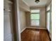 Bright room with hardwood floors, built-in storage and a big window looking onto front yard at 10856 Ellicot Way, Alpharetta, GA 30022