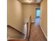 Hallway with carpet floors and wooden trim staircase at 10856 Ellicot Way, Alpharetta, GA 30022