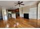 Spacious living area featuring hardwood floors, a fireplace, and an open layout to the kitchen at 10856 Ellicot Way, Alpharetta, GA 30022