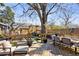 Expansive backyard featuring multiple seating areas, elegant landscaping, a charming daybed, and outdoor dining space at 1402 Sw Belmont Sw Ave, Atlanta, GA 30310
