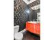 Unique bathroom with black damask wallpaper, red vanity, and modern fixtures at 1402 Sw Belmont Sw Ave, Atlanta, GA 30310
