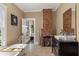 Charming bathroom with a brick fireplace, soaking tub, and vintage-style vanity at 1402 Sw Belmont Sw Ave, Atlanta, GA 30310