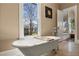 Relaxing bathroom with a soaking tub, a large window, and view of the outdoors at 1402 Sw Belmont Sw Ave, Atlanta, GA 30310