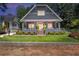 Beautifully landscaped front yard leading to a charming craftsman-style home with a welcoming porch at 1402 Sw Belmont Sw Ave, Atlanta, GA 30310