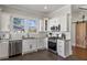 Stylish kitchen with stainless steel appliances, white cabinetry, and convenient layout at 1402 Sw Belmont Sw Ave, Atlanta, GA 30310