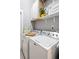 Functional laundry room with washer, dryer, and storage shelves at 1402 Sw Belmont Sw Ave, Atlanta, GA 30310