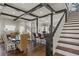 Open-concept living area with exposed beams, dining space, and kitchen access at 1402 Sw Belmont Sw Ave, Atlanta, GA 30310