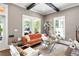 Bright living room featuring a stylish orange sofa, large windows, and elegant decor at 1402 Sw Belmont Sw Ave, Atlanta, GA 30310