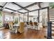 Open-concept living space with hardwood floors, dark wood beams, kitchen, and dining area at 1402 Sw Belmont Sw Ave, Atlanta, GA 30310