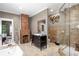 Bright bathroom featuring dual vanities, an antique brick fireplace, and a glass-enclosed shower at 1402 Sw Belmont Sw Ave, Atlanta, GA 30310
