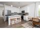 Stylish kitchen featuring white cabinetry, island seating, stainless appliances, and a cozy dining area at 1724 Gunnin Nw Trce # 232, Atlanta, GA 30318