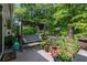 Relaxing back deck with plenty of potted plants, comfortable seating, and wooded views at 1824 Mcclung Rd, Hiram, GA 30141