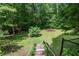 Spacious backyard with mature trees, green grass, privacy, and fire pit at 1824 Mcclung Rd, Hiram, GA 30141