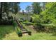 Charming backyard with a wooden staircase and a lush landscaped garden at 1824 Mcclung Rd, Hiram, GA 30141