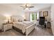 Cozy bedroom features neutral walls, window, ceiling fan, a desk, and plush carpeting at 1824 Mcclung Rd, Hiram, GA 30141