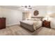 Spacious primary bedroom with neutral carpet, a ceiling fan, and large bed at 1824 Mcclung Rd, Hiram, GA 30141
