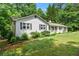 Traditional home with white siding, complemented by dark shutters and a neatly landscaped front yard at 1824 Mcclung Rd, Hiram, GA 30141